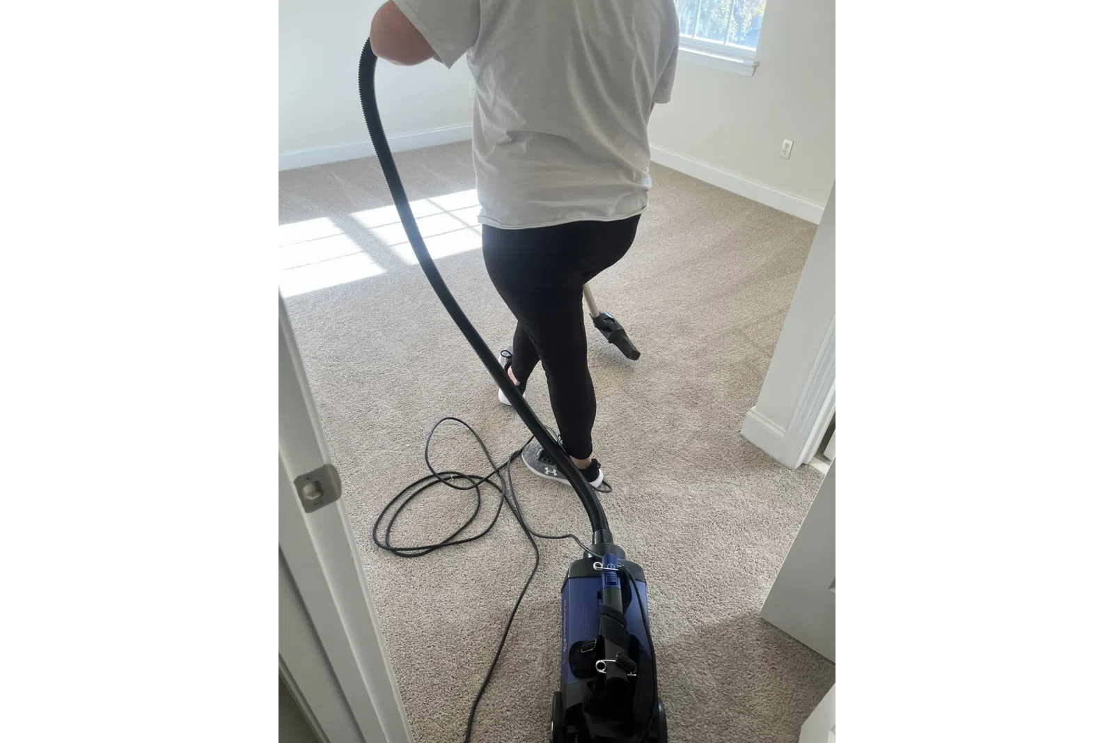 MaidPro Charleston vaccuming a bedroom floor in North Carolina