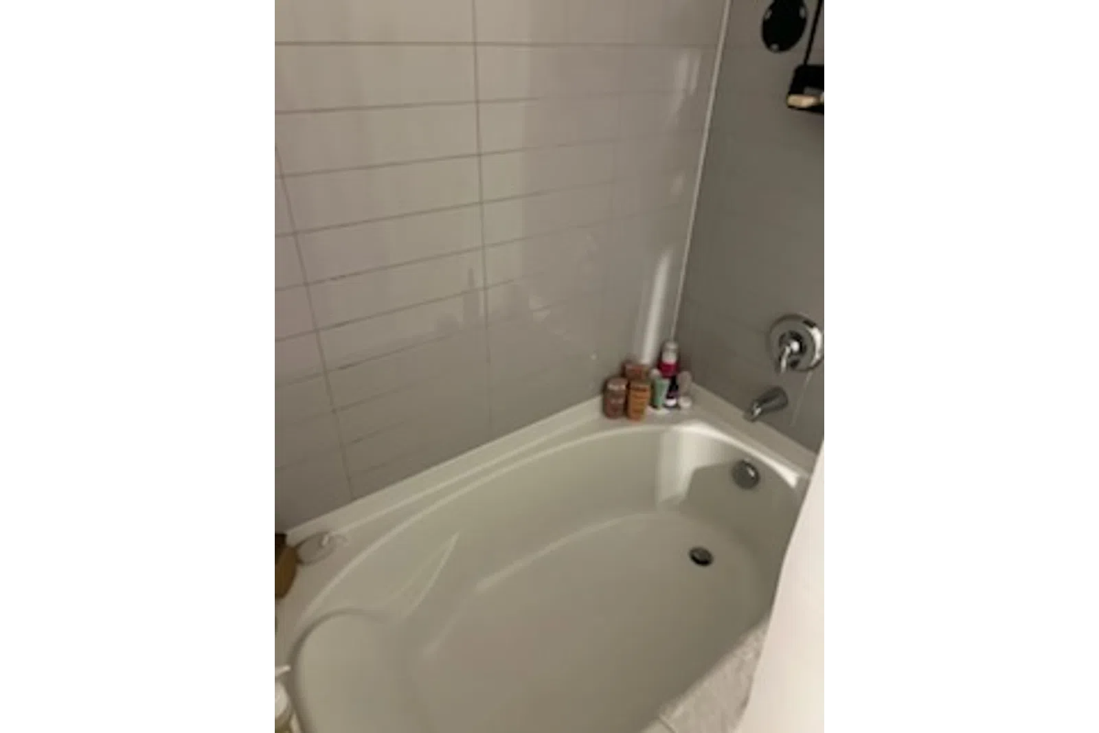 a bathtub with a sink and a shower unit