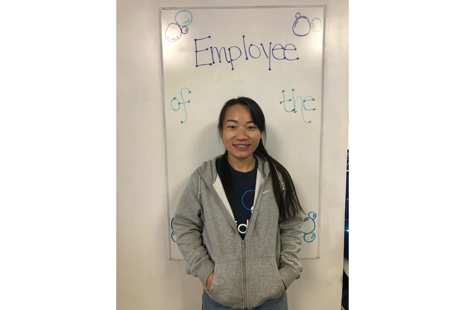 a person standing in front of a white board with writing on it