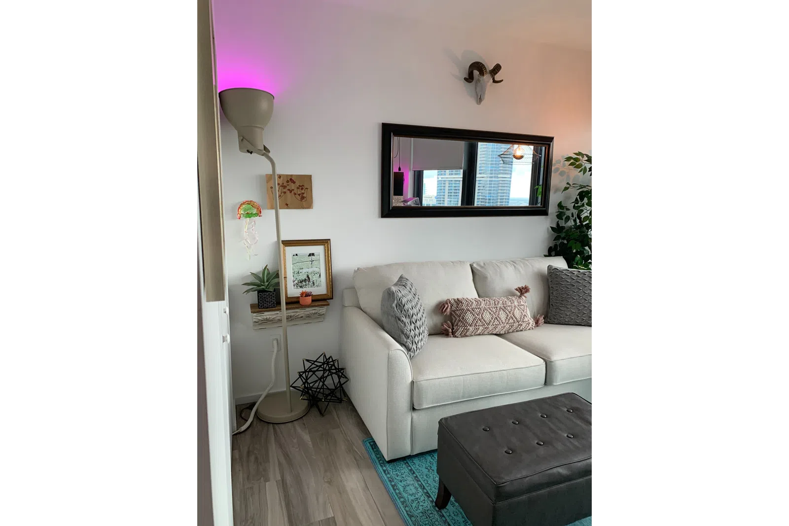 a living room with a white wall and a white couch