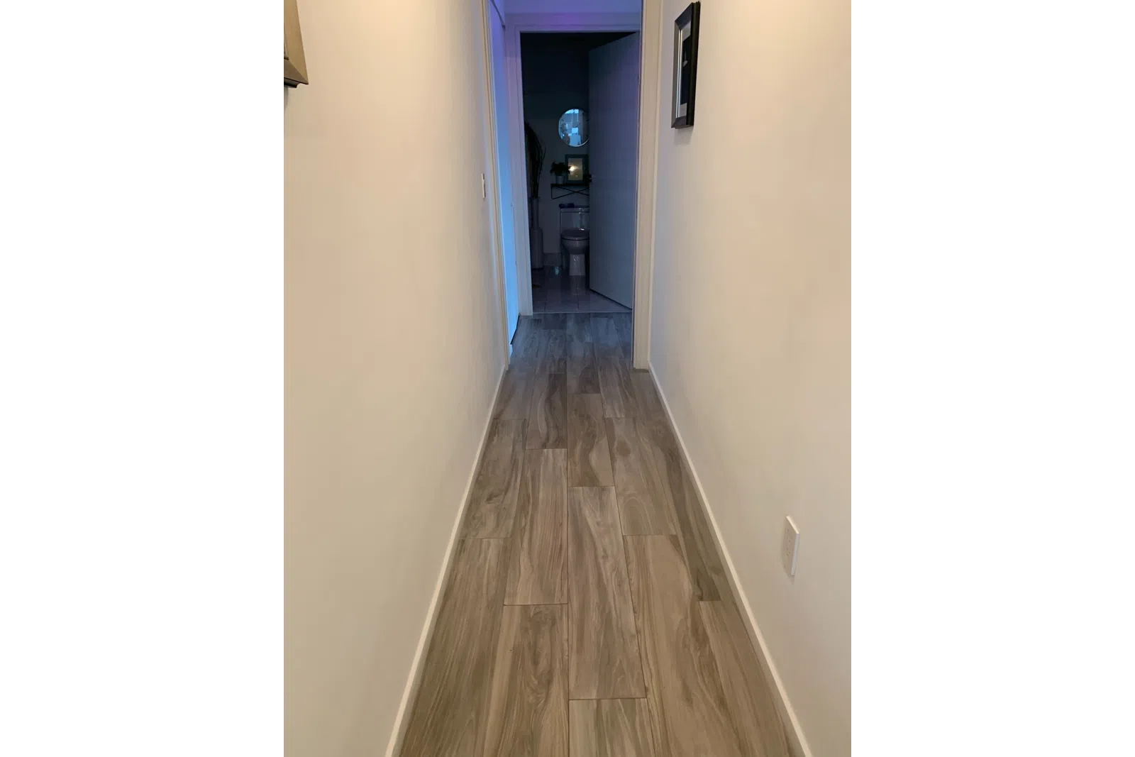 a room with a tv and a wall with a light