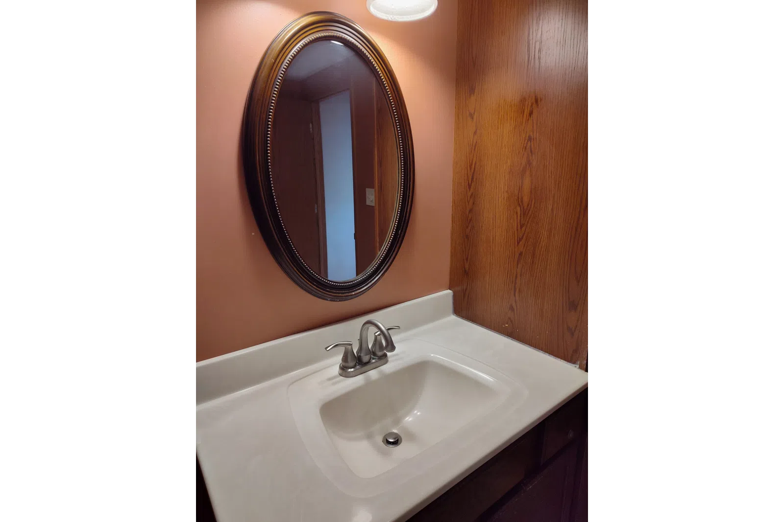 a bathroom sink with a mirror above it