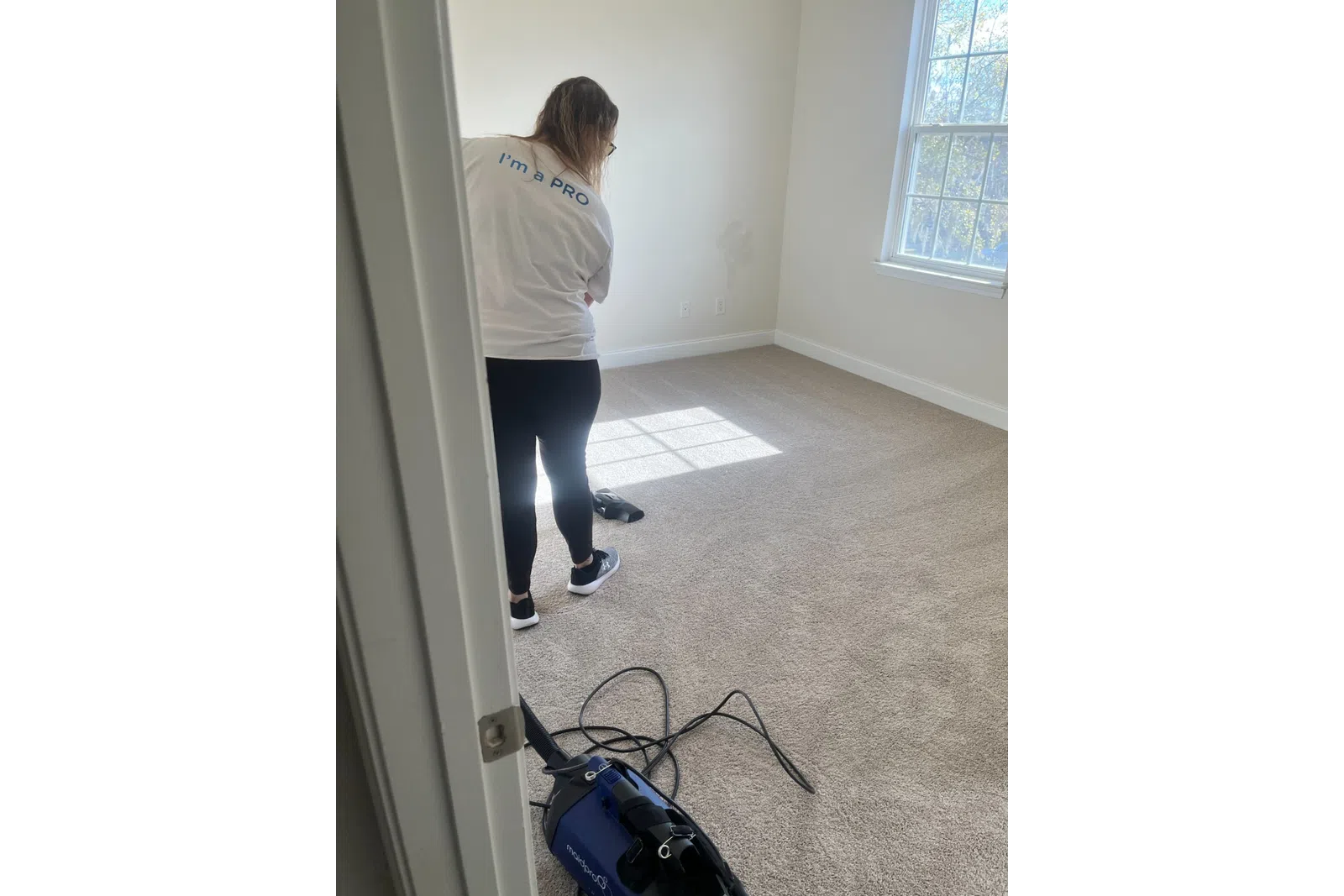 MaidPro Charleston cleaning services professional vaccuming a carpet floor