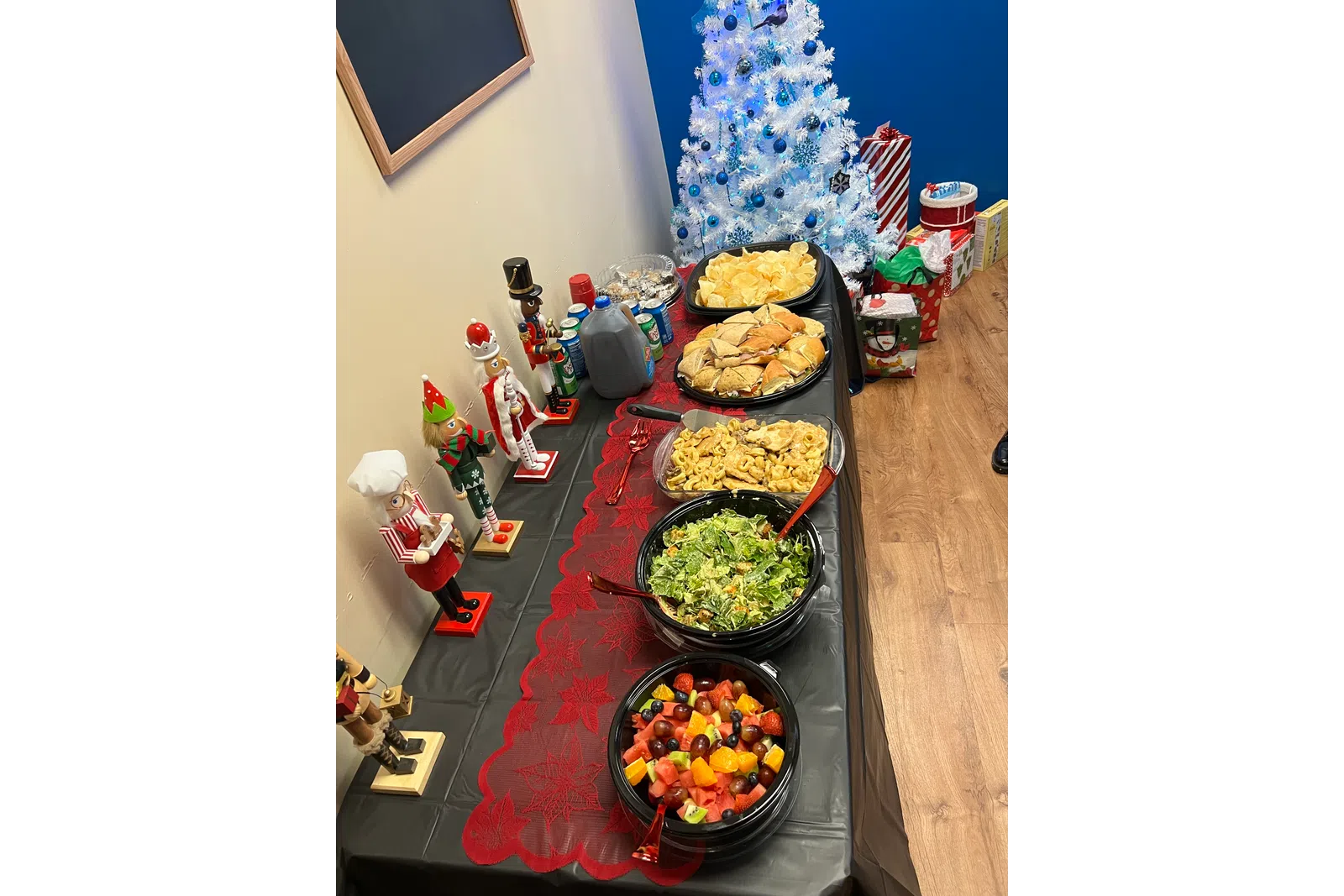 a table with food and a christmas tree in the background