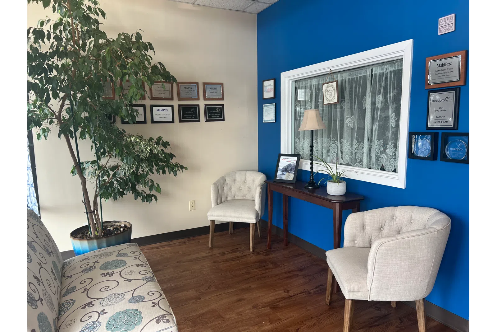 a room with a desk and chairs