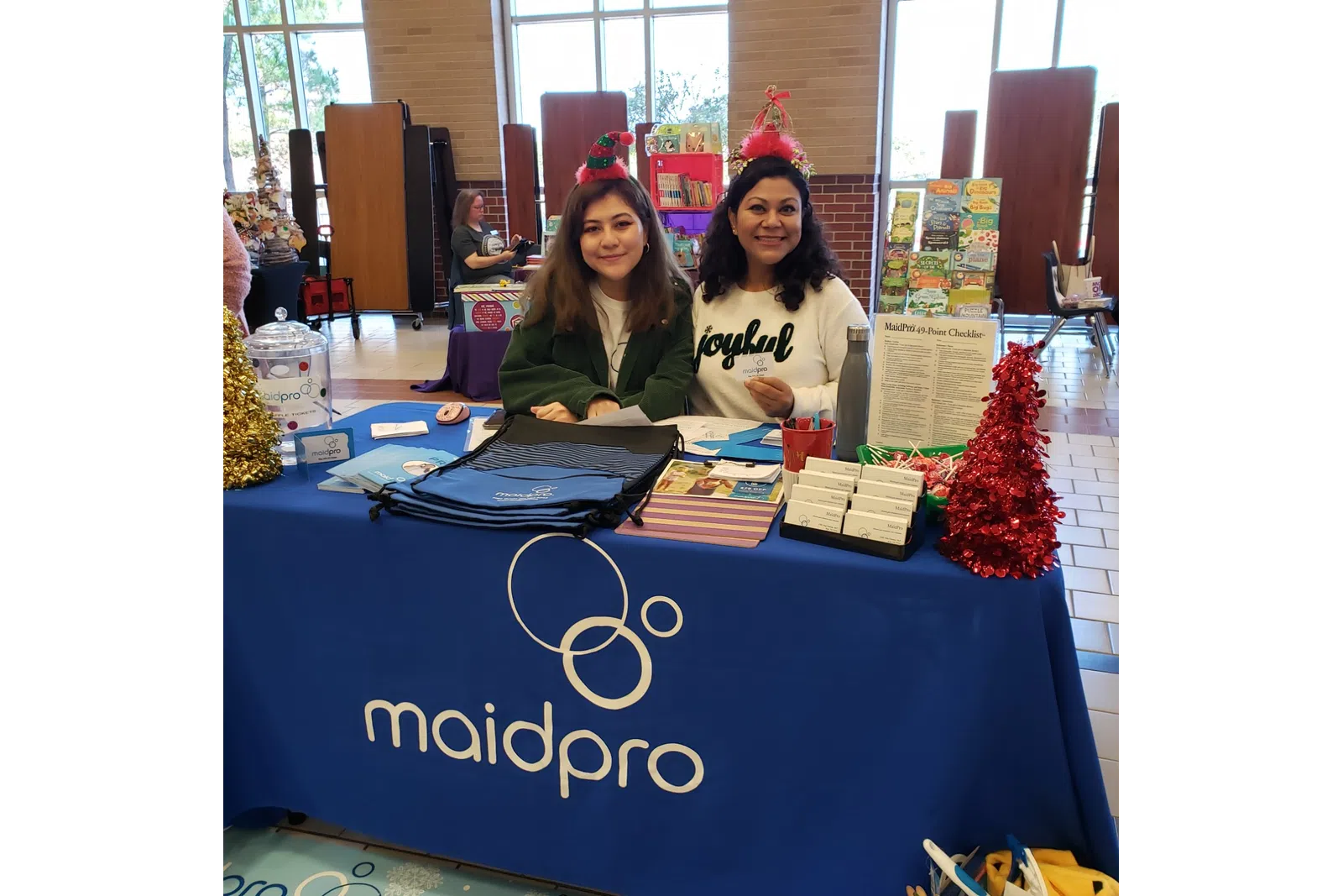 two employees at a local event for MaidPro Houston Central