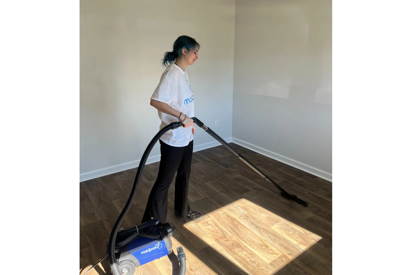 MaidPro Charleston house cleaner vaccuming a hardwood floor in North Carolina