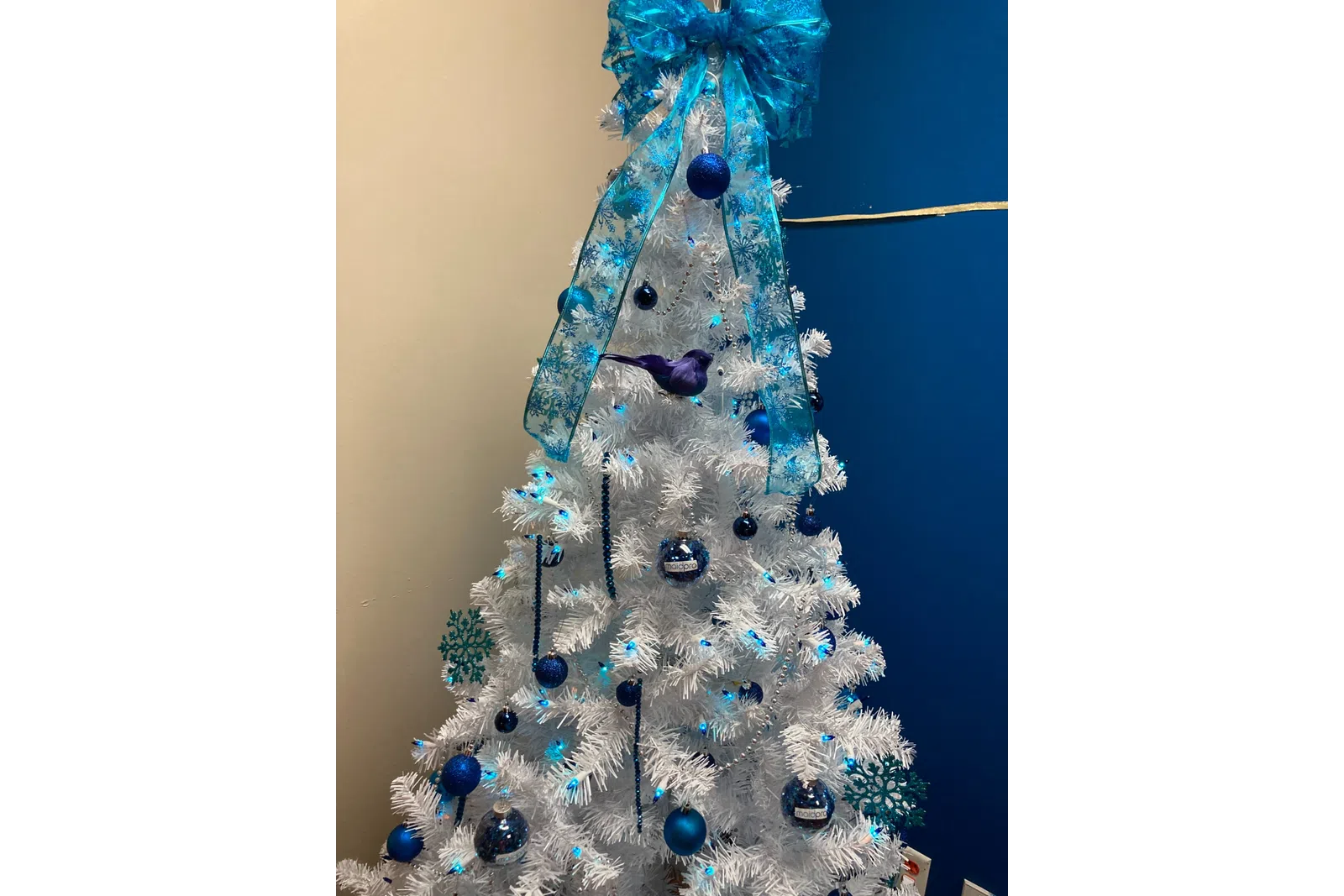 a blue and white object with blue crystals on it