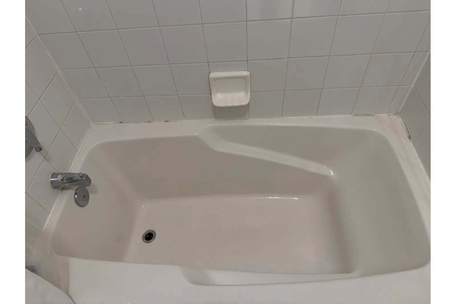a bathtub with a tissue box