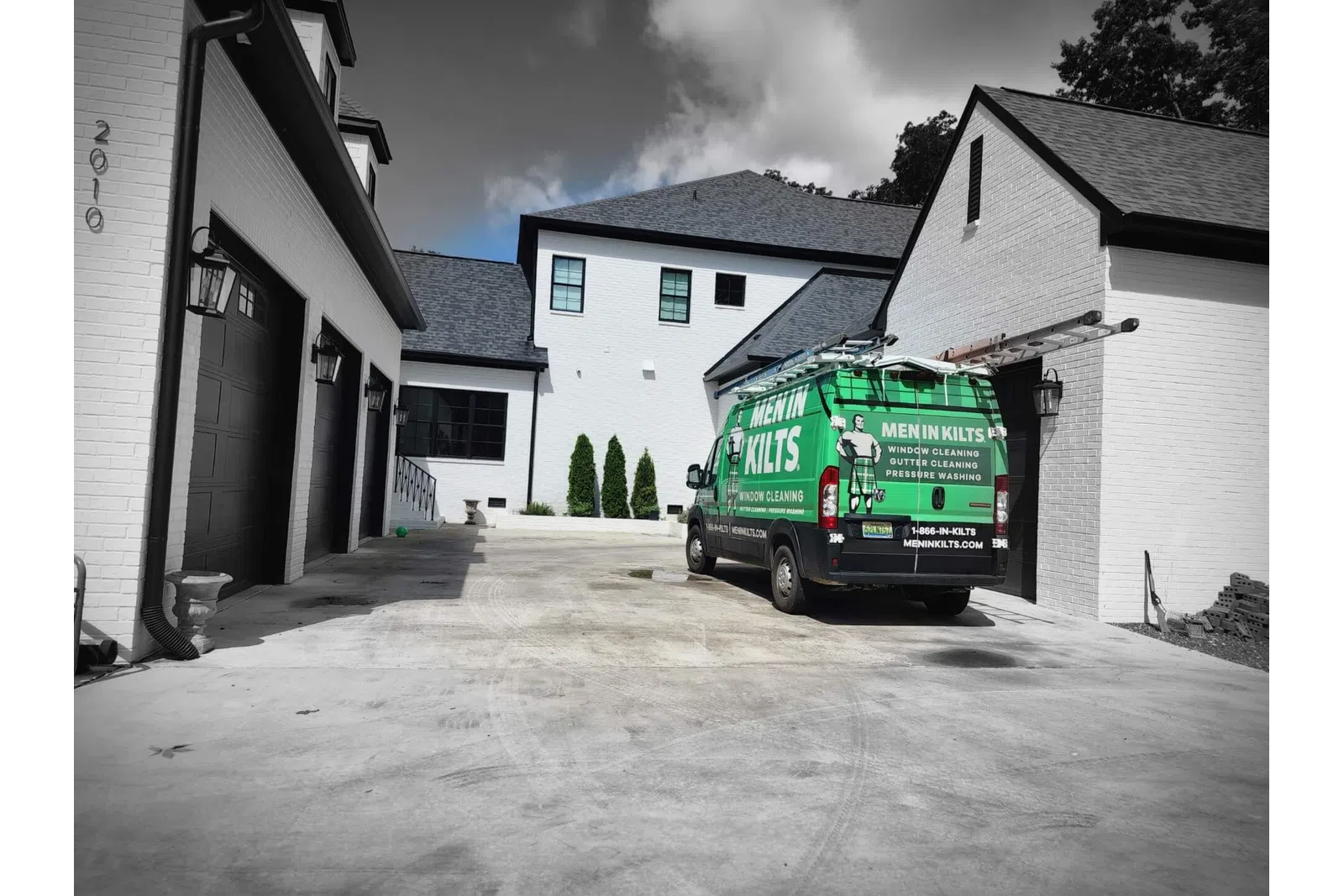 a green van parked in a driveway