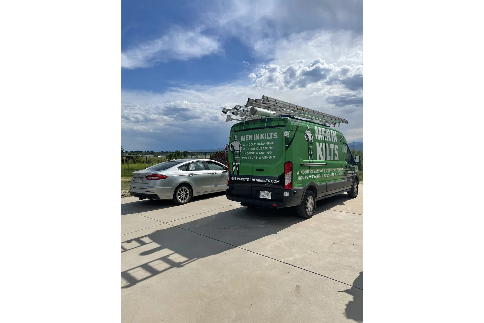 a green truck and a silver car