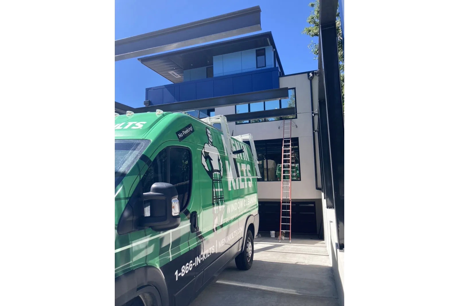 a green bus parked outside a building