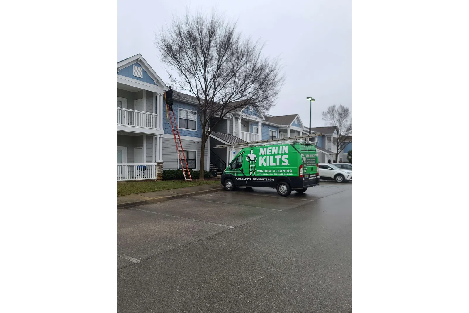 a green truck parked on the side of a street