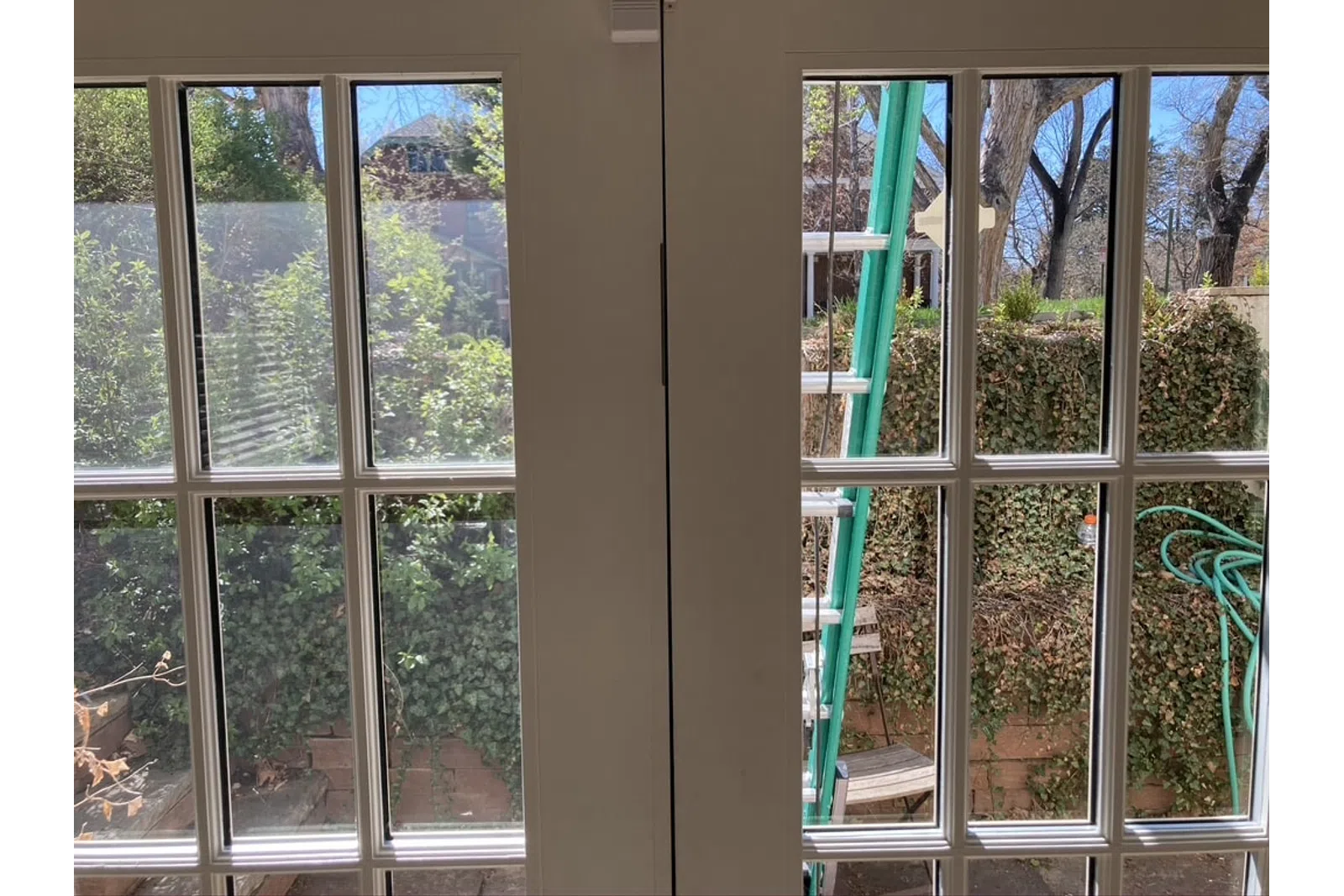 a room with windows and a ladder