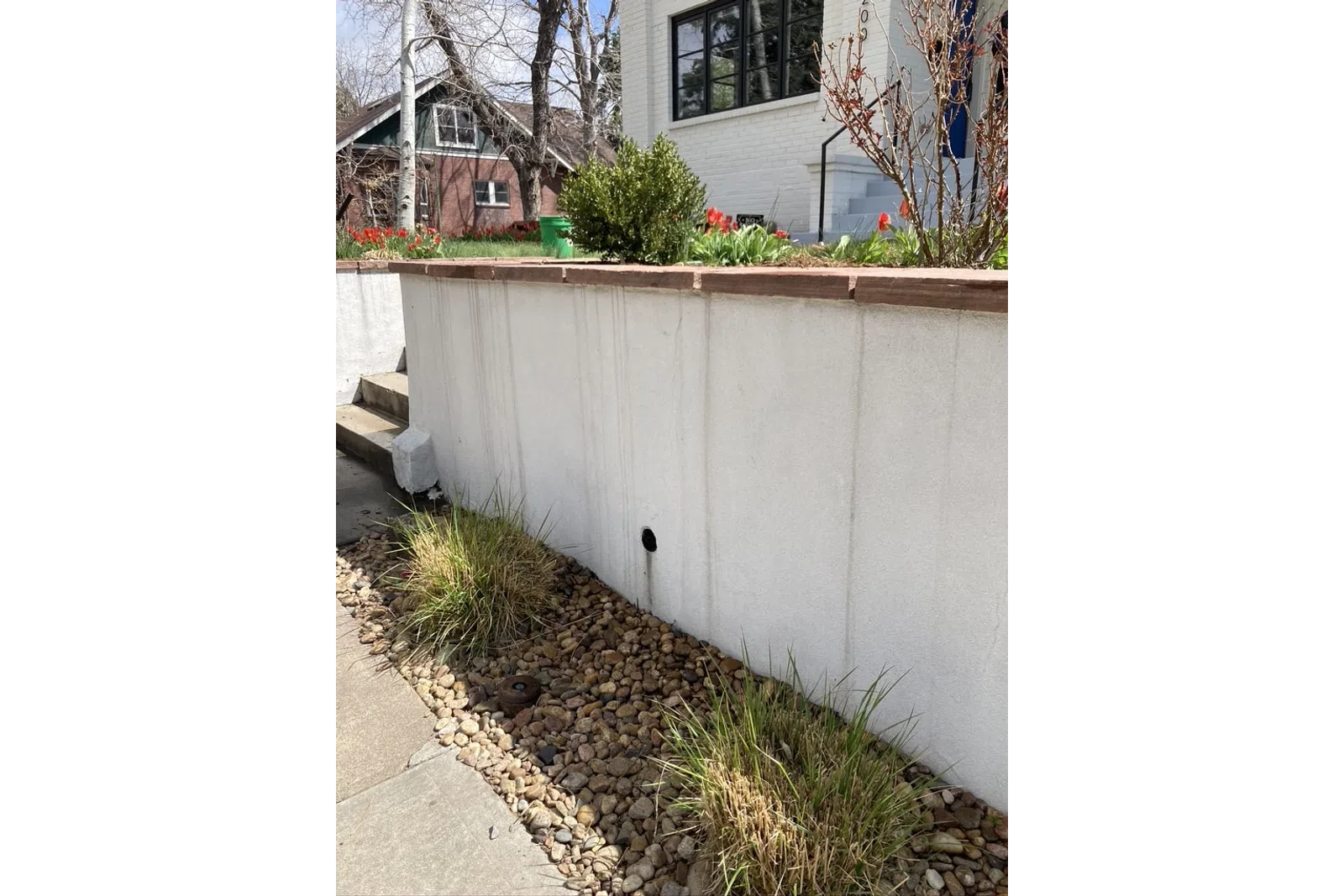 a white wall with a planter