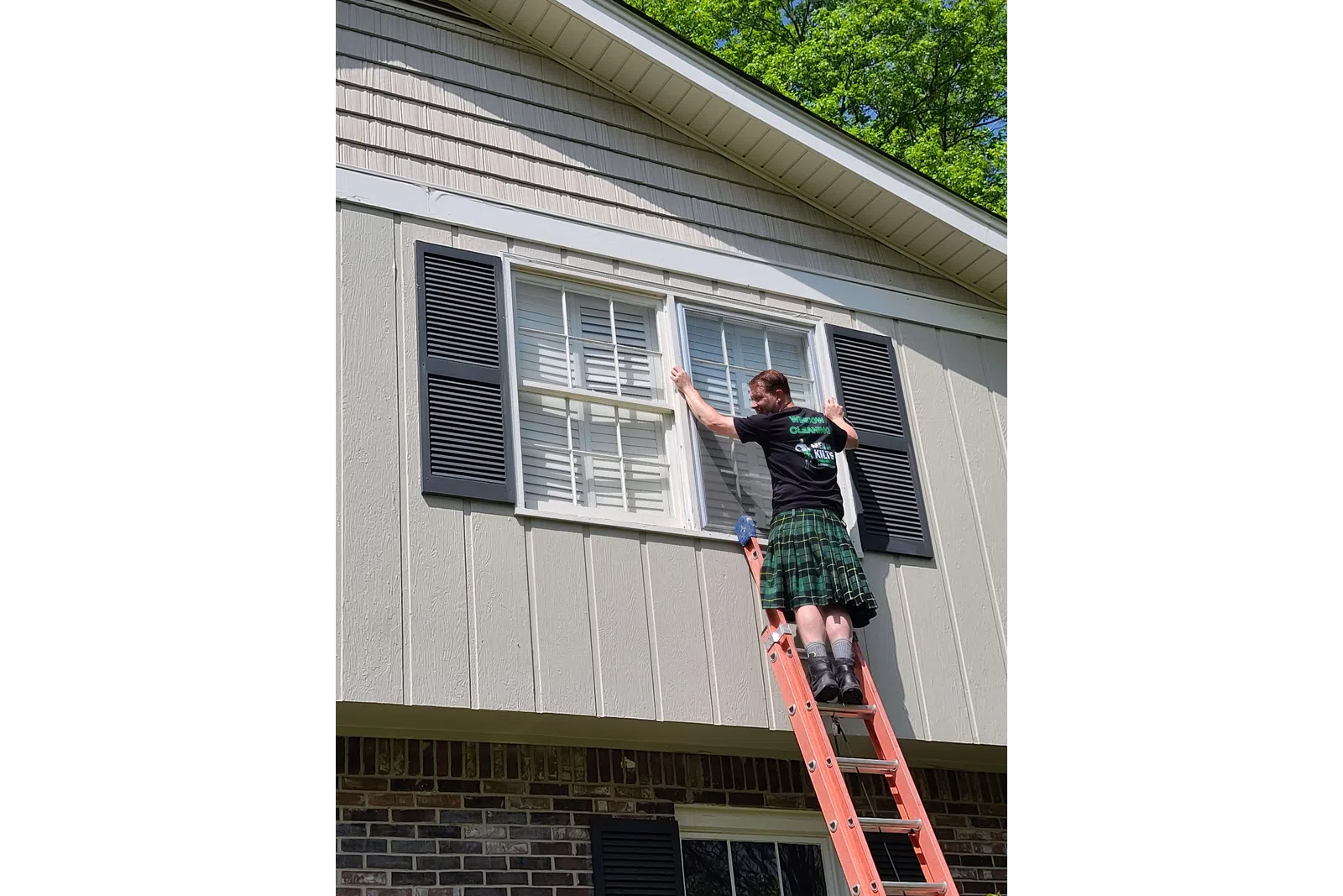 a person on a ladder on a house