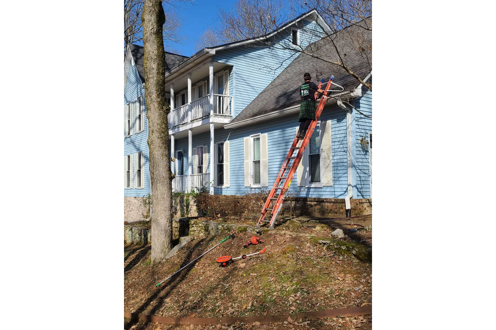 a person on a ladder on a house