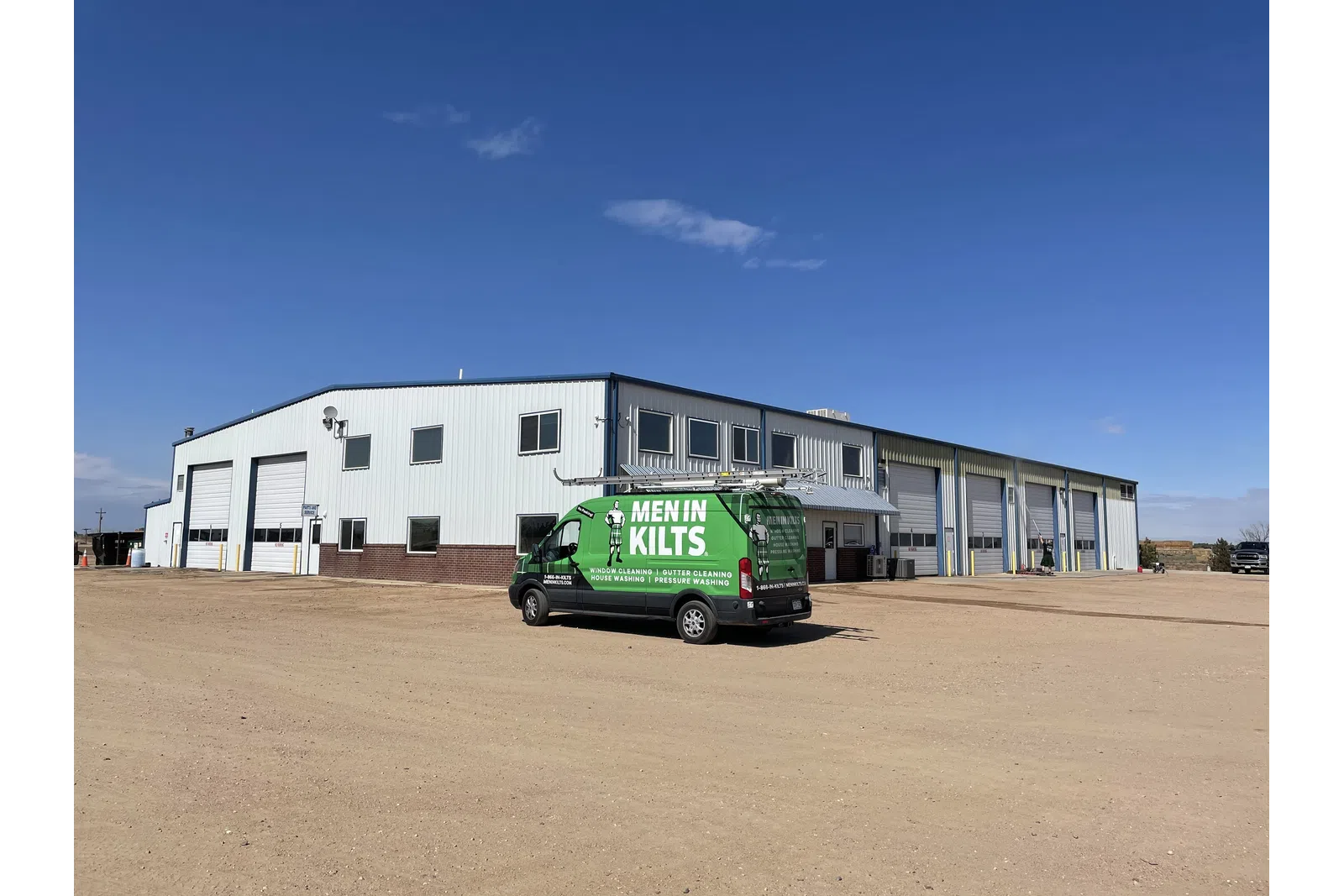 a green truck parked in front of a building