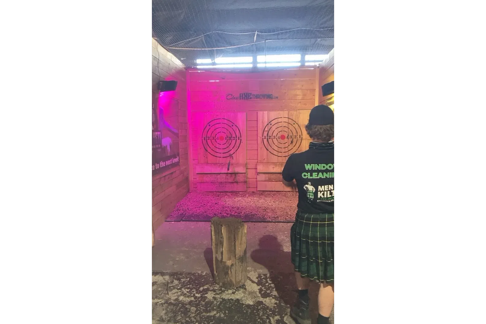 a person standing next to a pink box with a sign on it