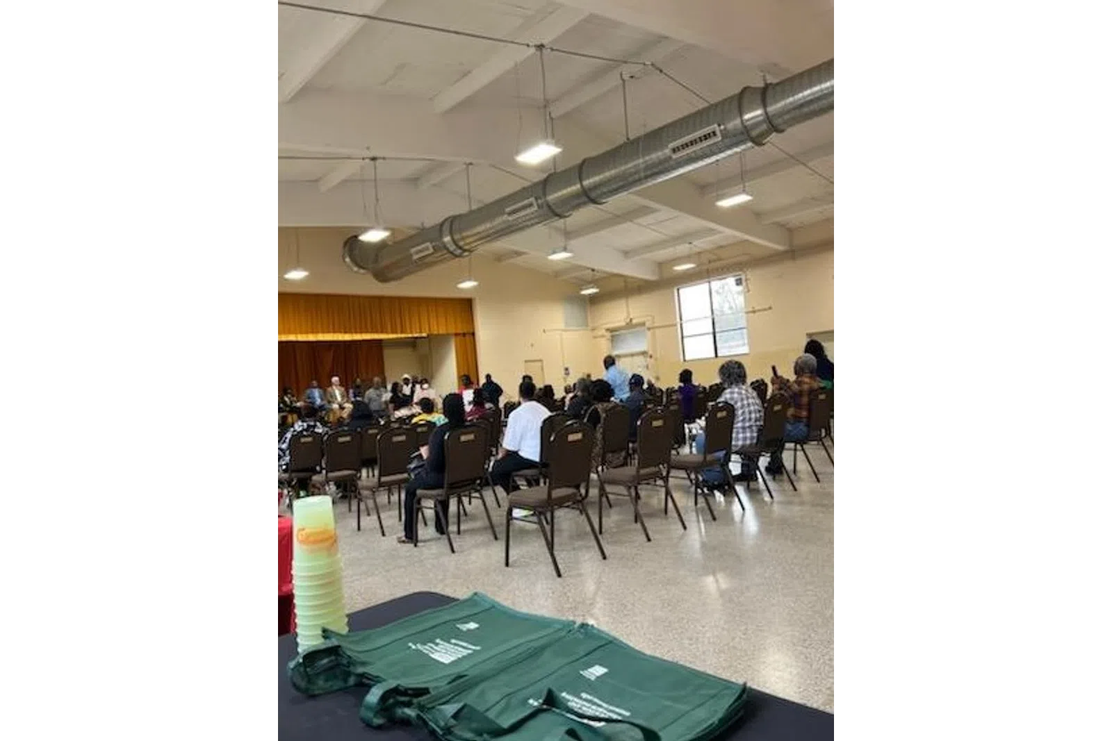 a group of people sitting in a room with a large screen