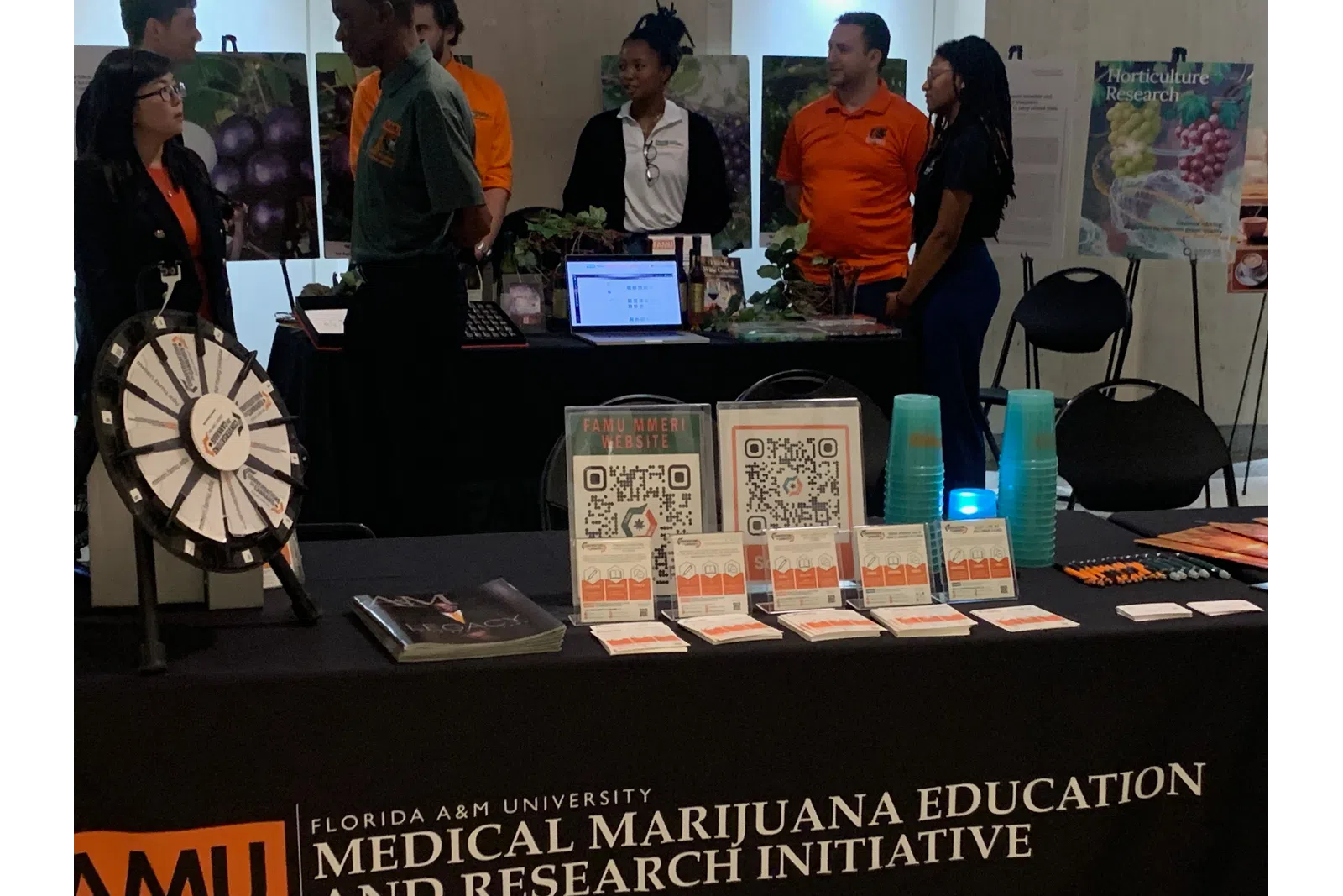 Educational booth at Florida A&M University Medical Marijuana Education Research Initiative event with people and
