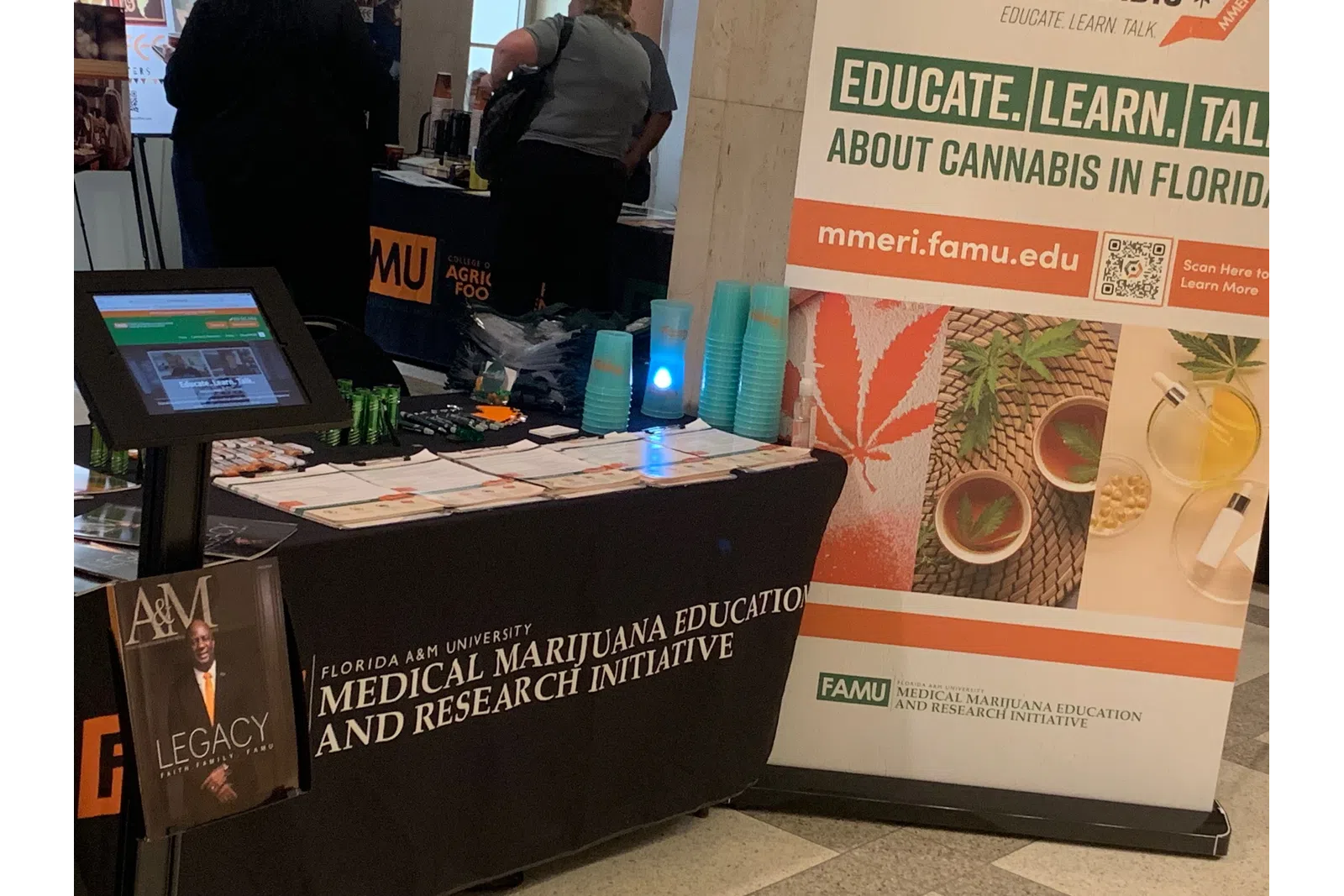 Florida A&M University Medical Marijuana Education and Research Initiative booth with informational materials and banner