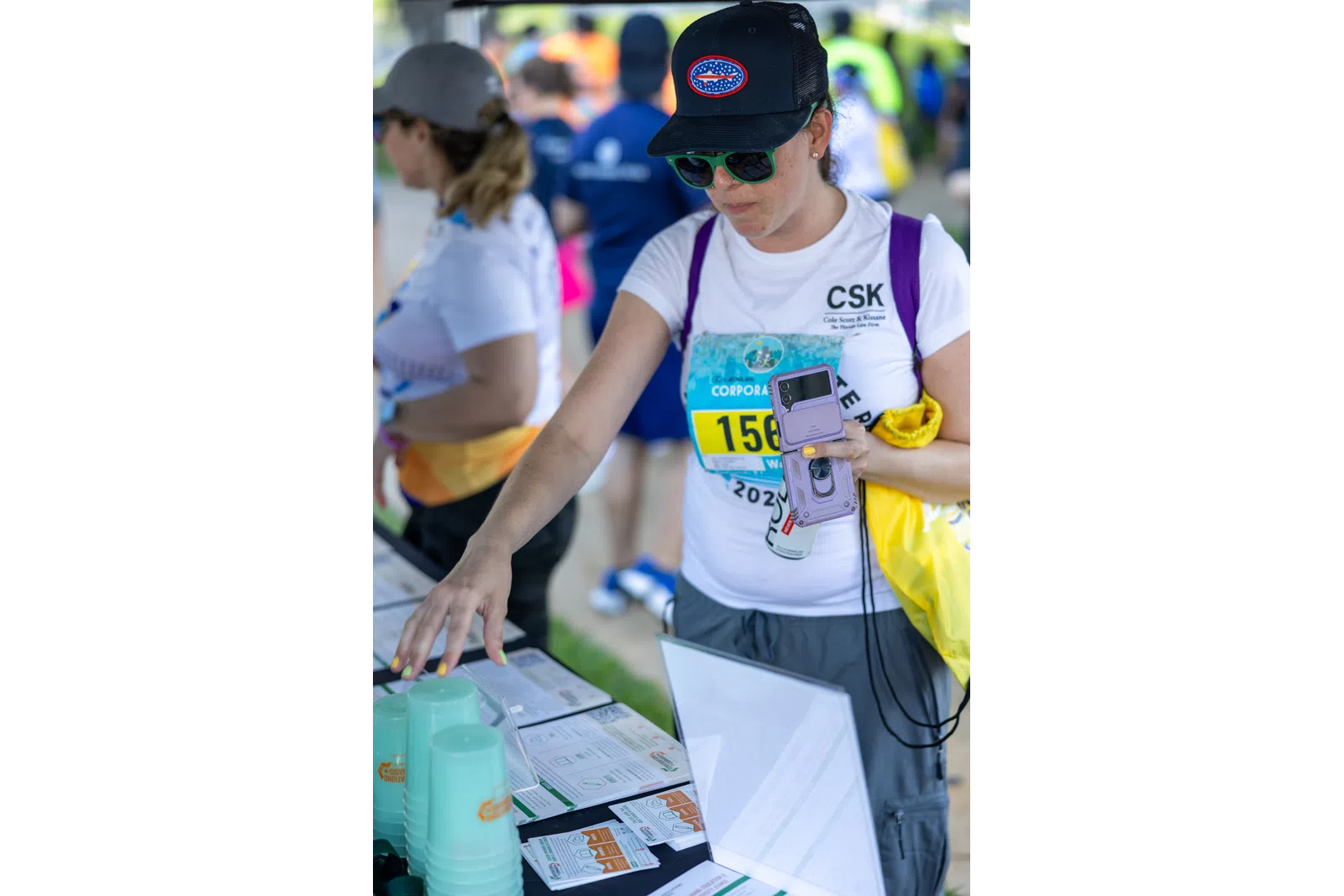 a person in a hat holding a cell phone