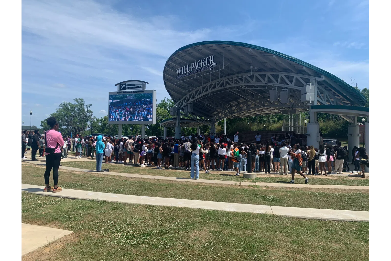 Crowd gathers at Will Packer outdoor stage under clear sky during daytime event