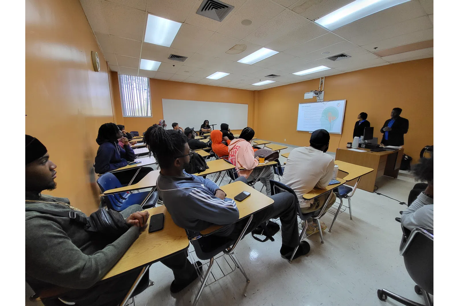 a group of people sitting in a classroom