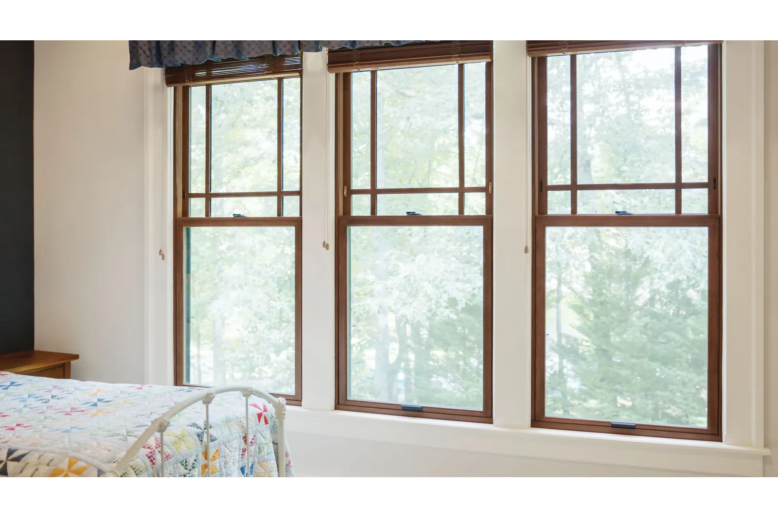 Triple-window configuration with brown double hung windows, a popular window replacement style for residential homes in Nashville, TN.