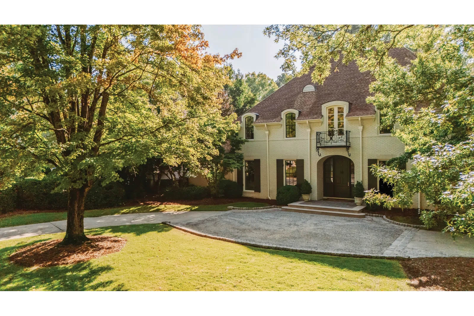 Custom arched fiberglass windows on a classic two-story brick home in Nashville, TN.
