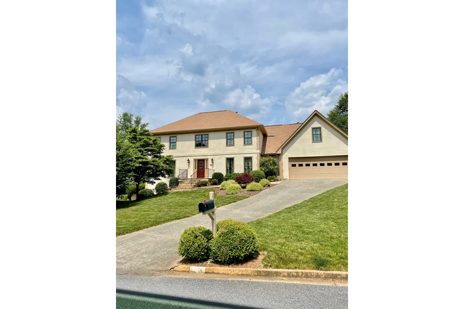 a house with a lawn and trees