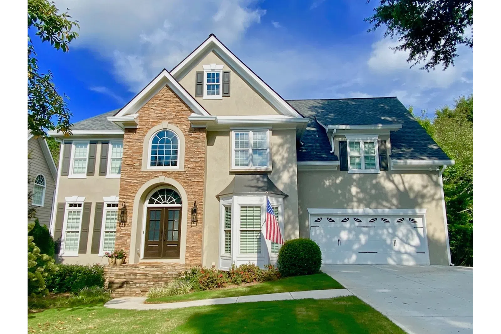 a large brick house with a flag on the front