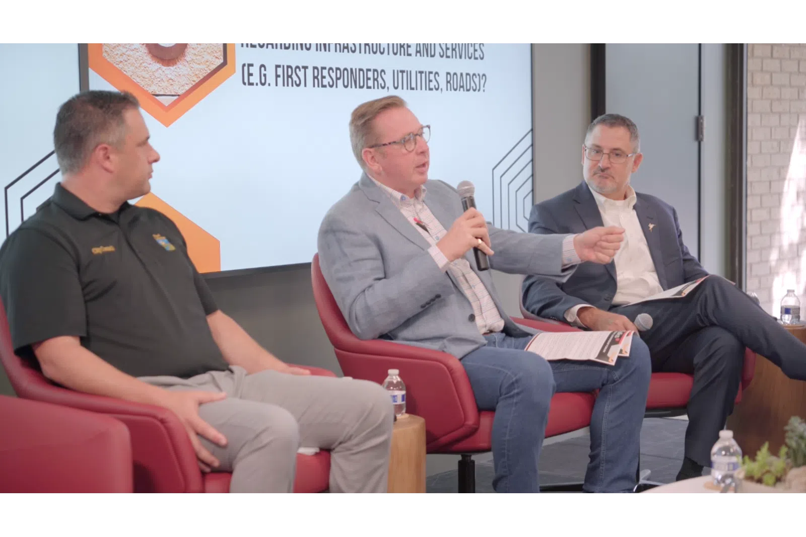 men sitting in chairs talking