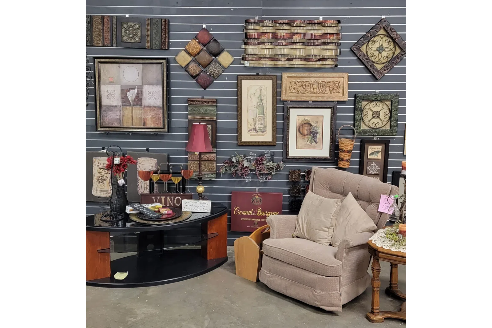 a living room with a wall of art and a couch