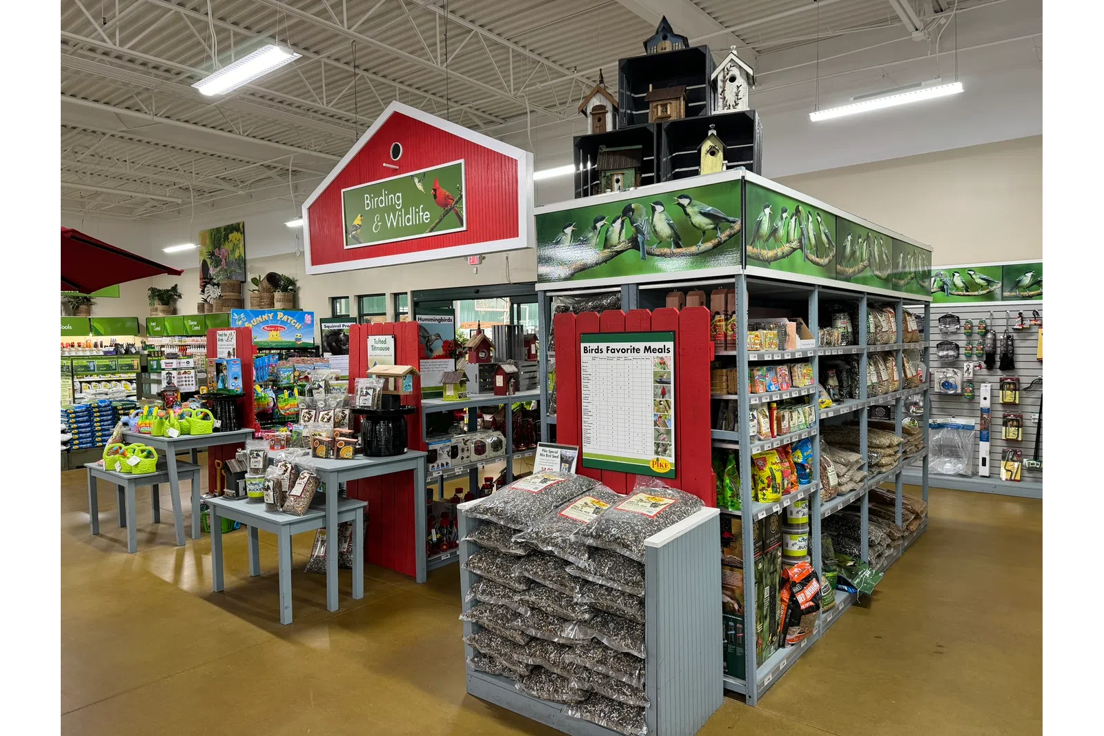 Store section for birding and wildlife supplies with birdseed, feeders, and birdhouses on display.