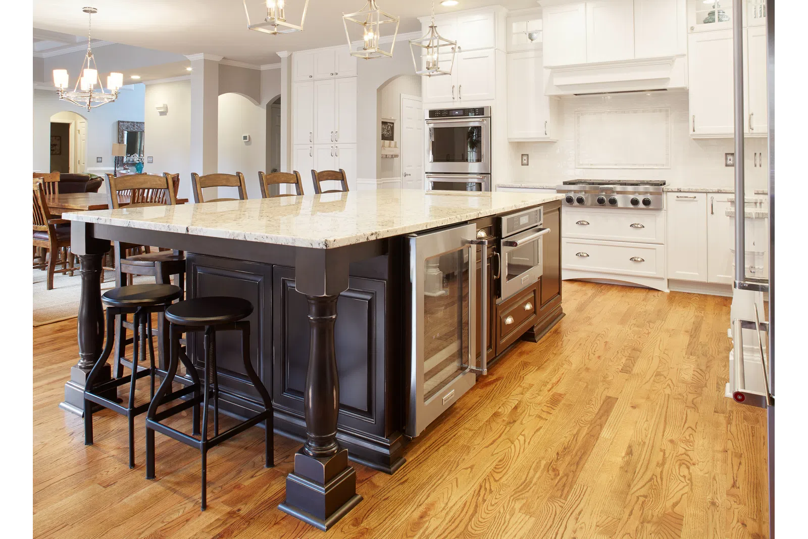a large kitchen with stainless steel appliances and wooden cabinets