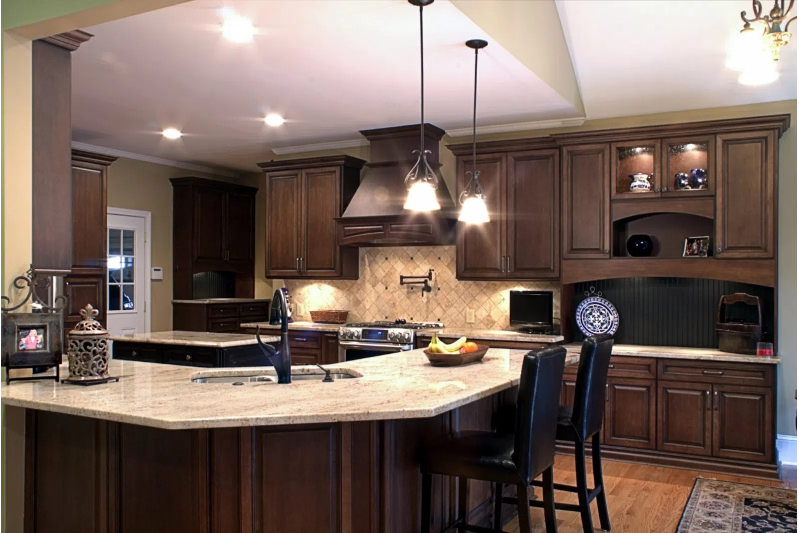 a modern kitchen with stainless steel appliances and wooden cabinets