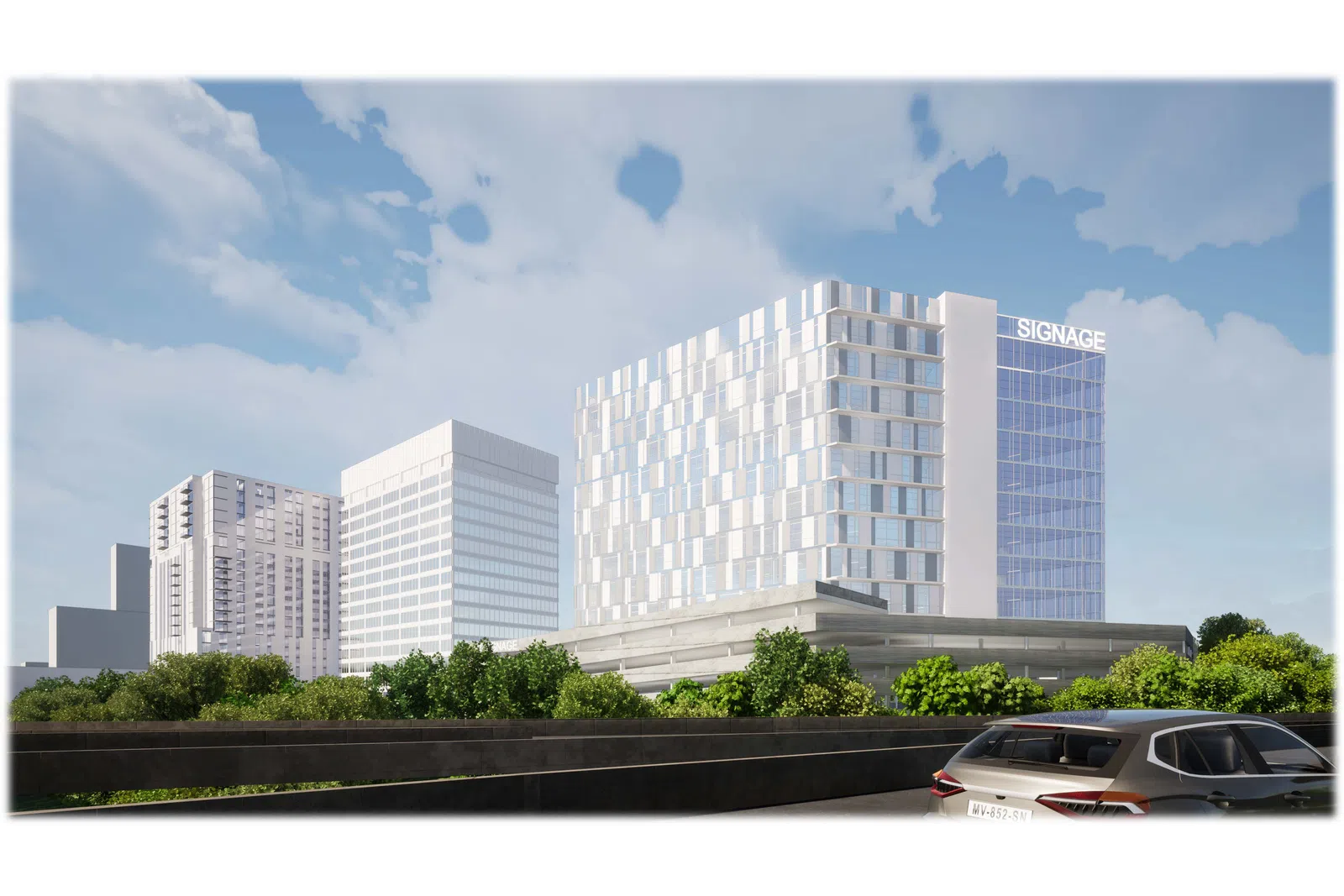 Modern office buildings with reflective glass windows behind green trees under a blue sky with clouds