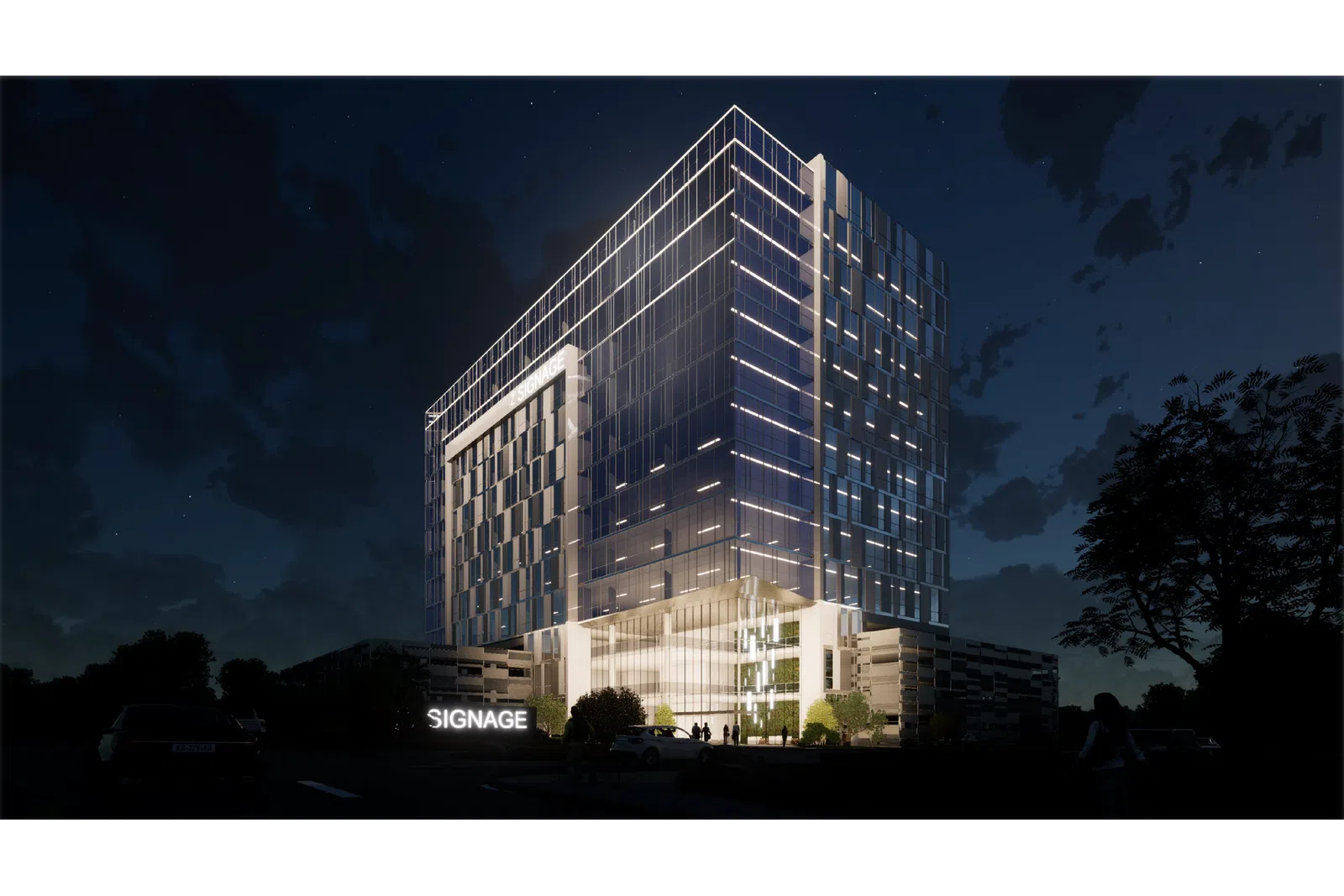 Modern glass office building illuminated at night with signage and surrounding trees under a starry sky.