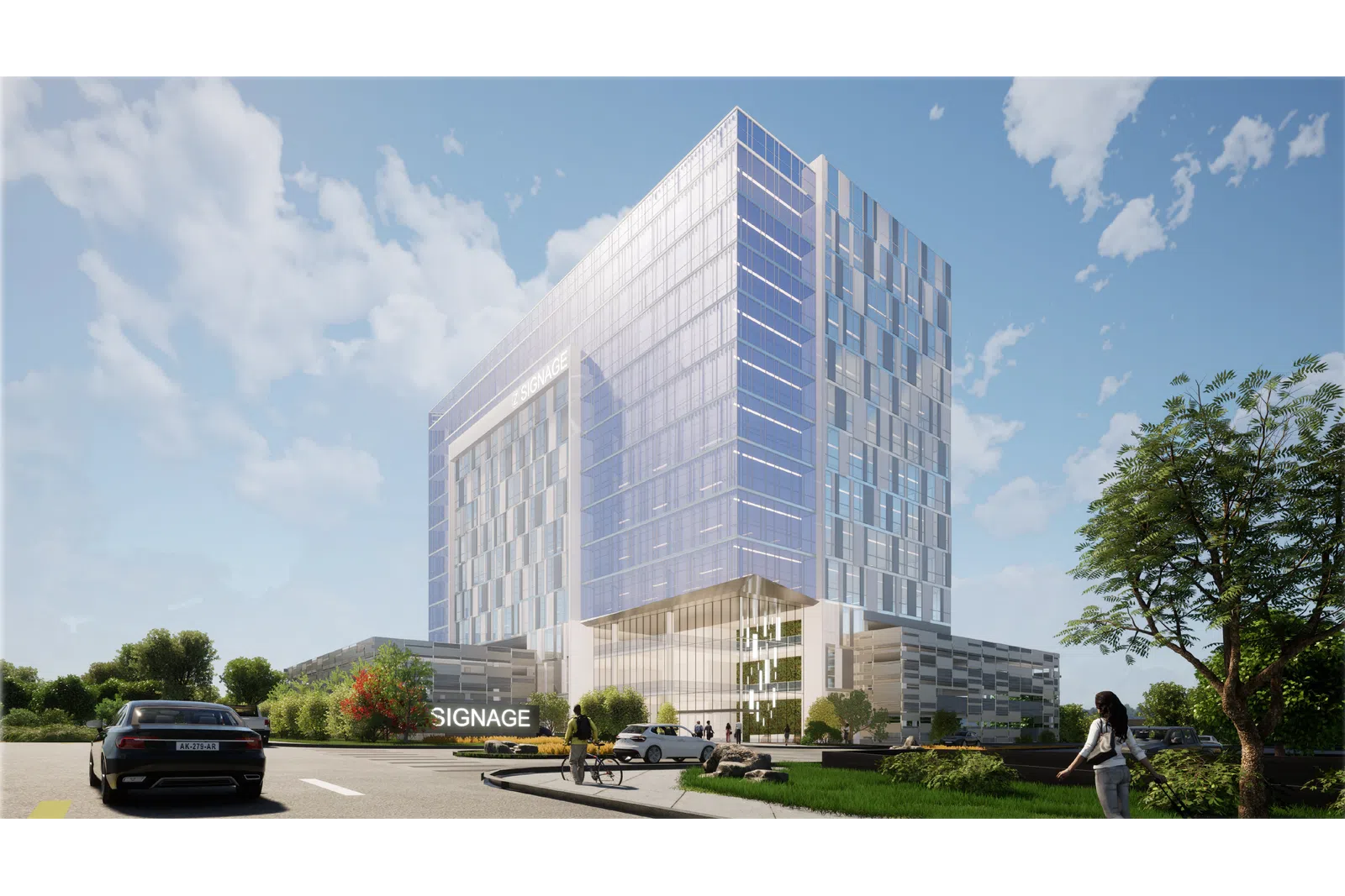 Modern glass office building with reflective windows under blue sky, surrounded by greenery and cars.