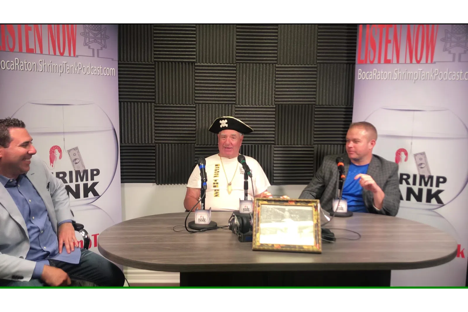 a group of men sitting at a table with microphones
