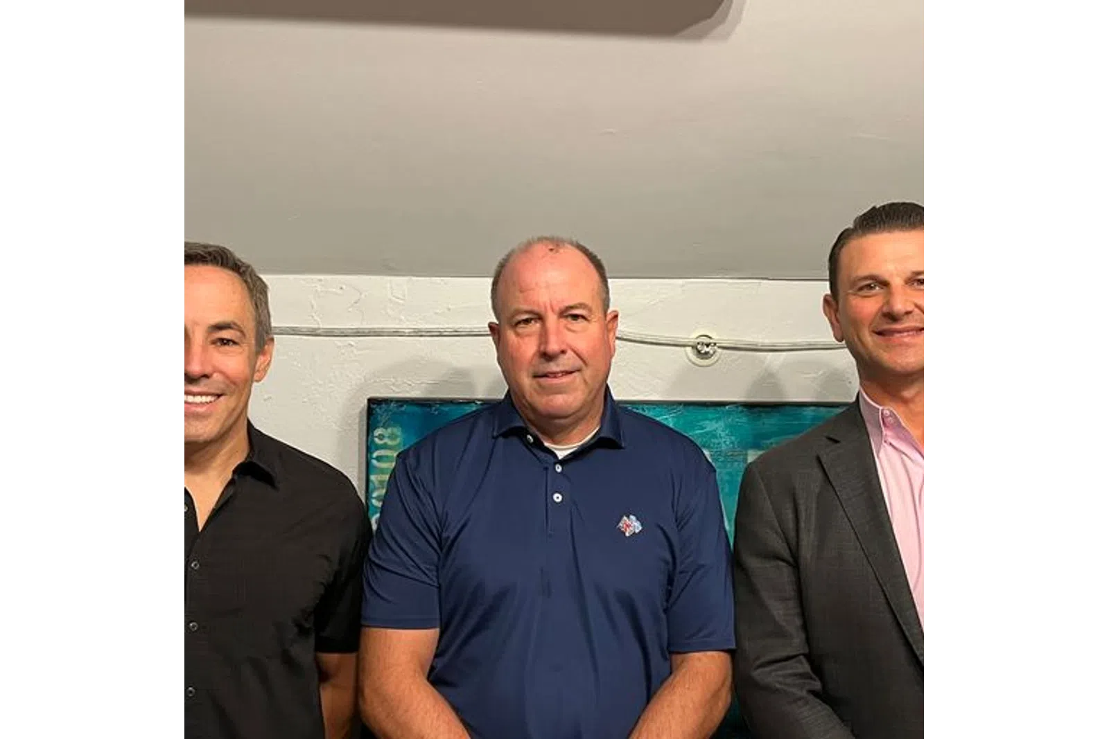 a group of men smiling