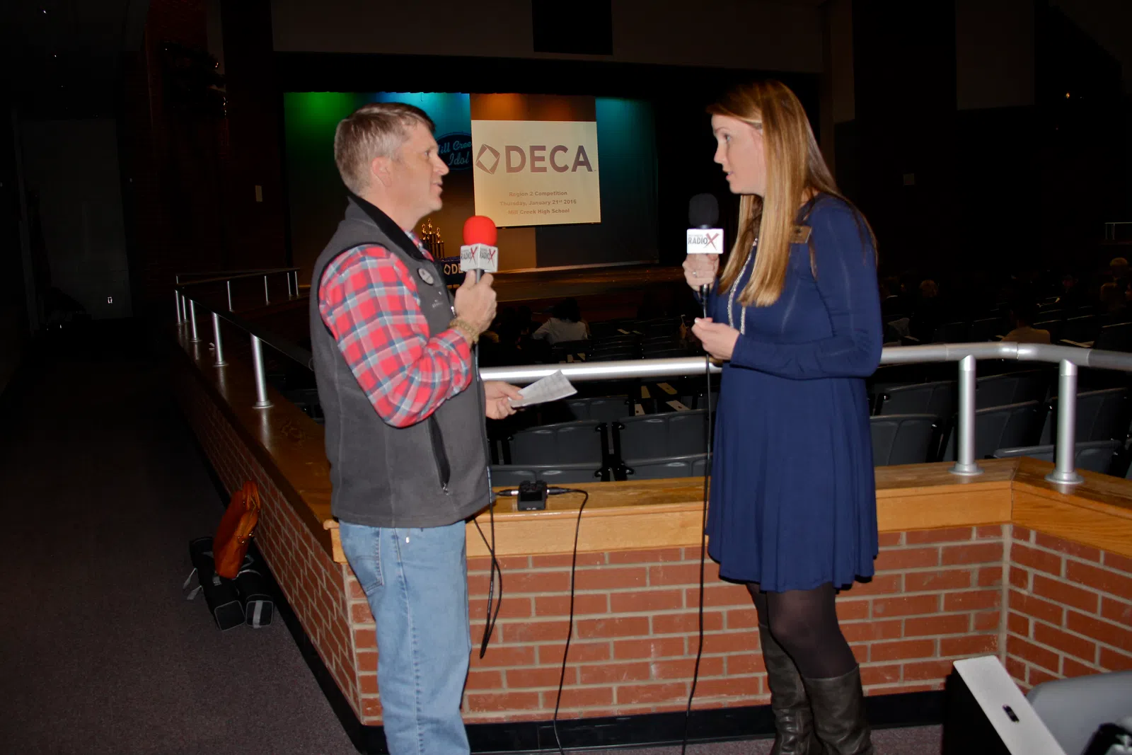 a man and woman holding microphones
