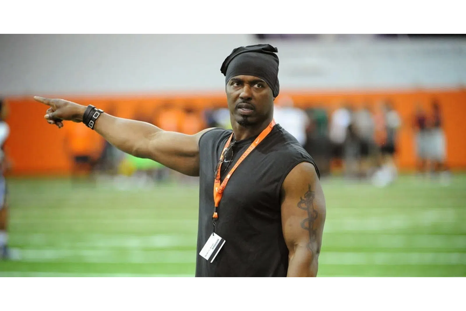 Brian Dawkins with a hat and a black shirt with the arms out