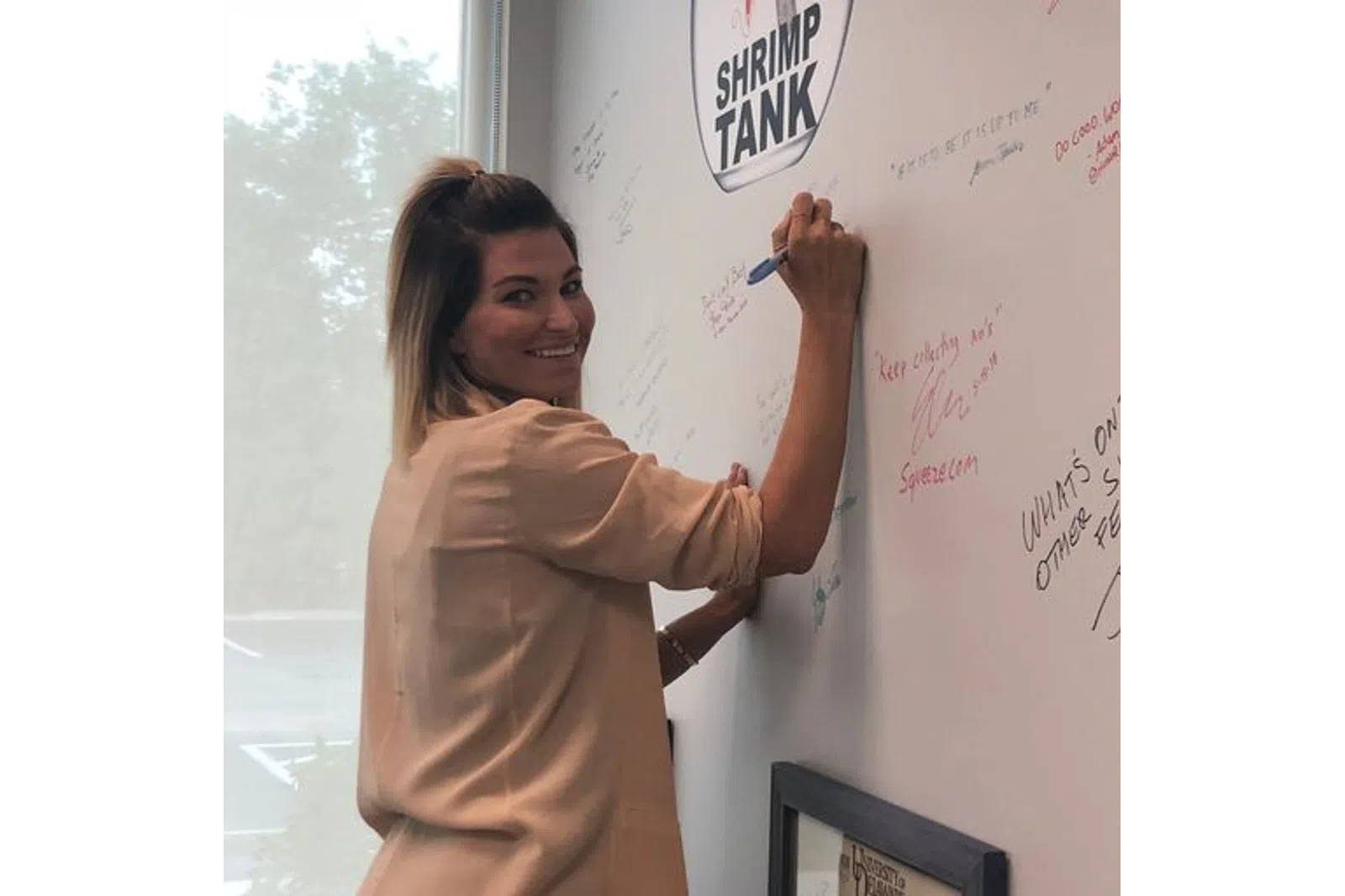 a person writing on a white board