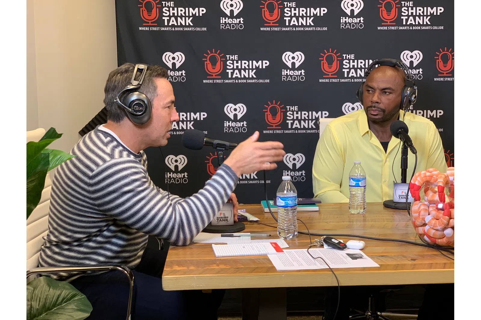 Toney Freeman wearing headphones and sitting at a table with a microphone