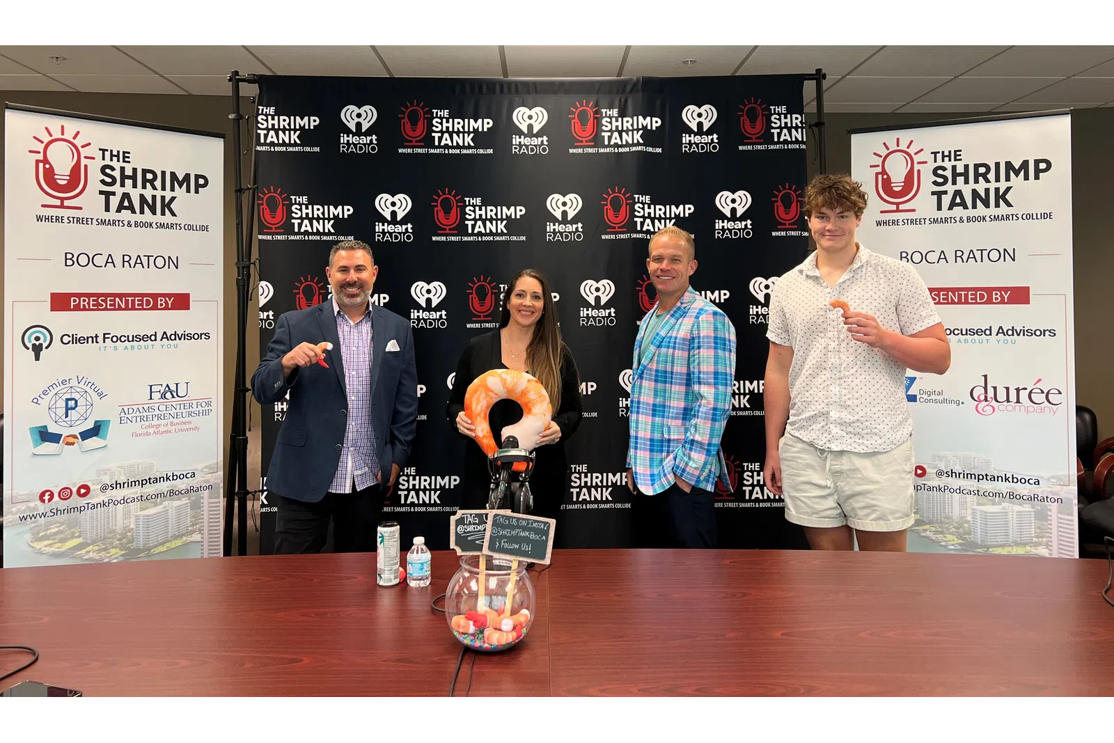 a group of people standing at a podium with a trophy