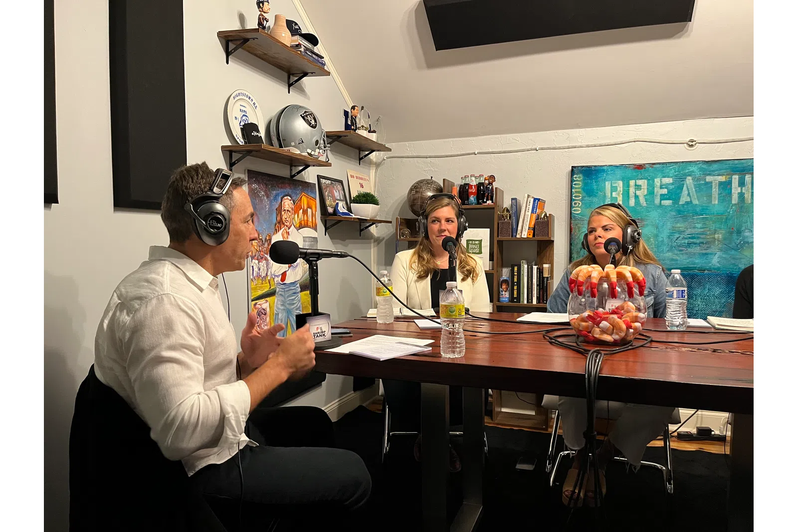 a group of people sitting at a table with microphones