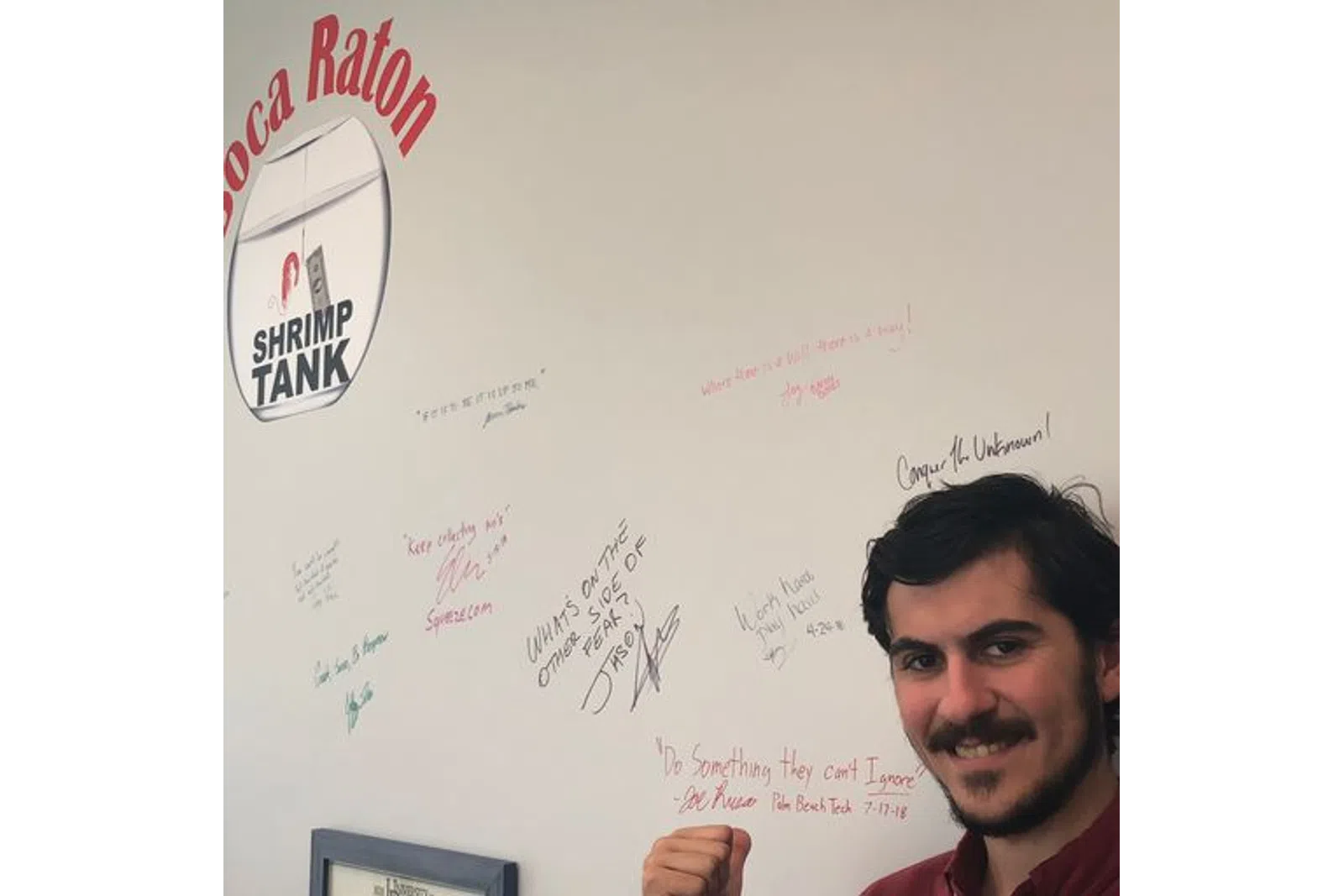 a person standing in front of a whiteboard with writing on it